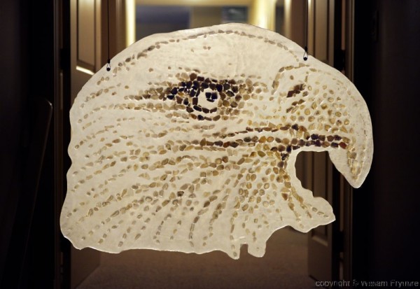 the side profile of an eagle's head made up of agate stones as a mosaic