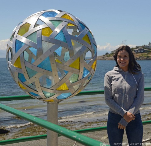 Artists daughter beside Reflect and Connect. Public Art by Bill Frymire